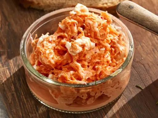 Pyszna pasta z rzodkiewki z kawałkami jajka w szklanej miseczce, gotowa do podania na chlebie.